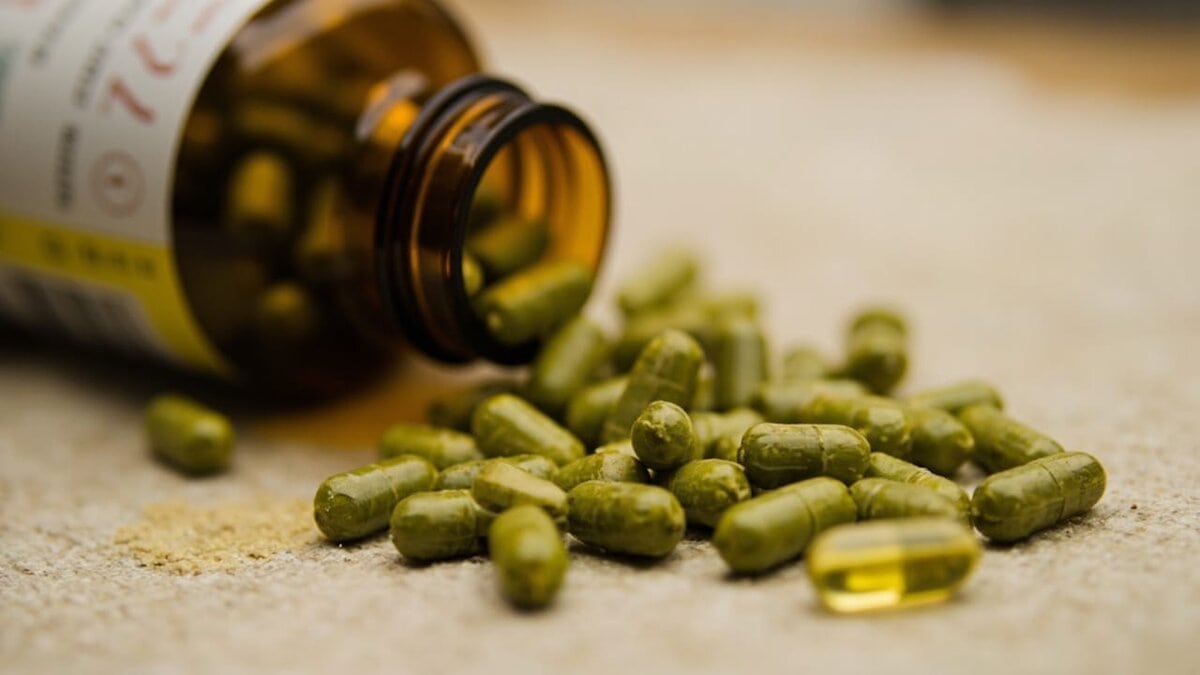 green tea extract for weight loss - capsules spilling from amber supplement bottle