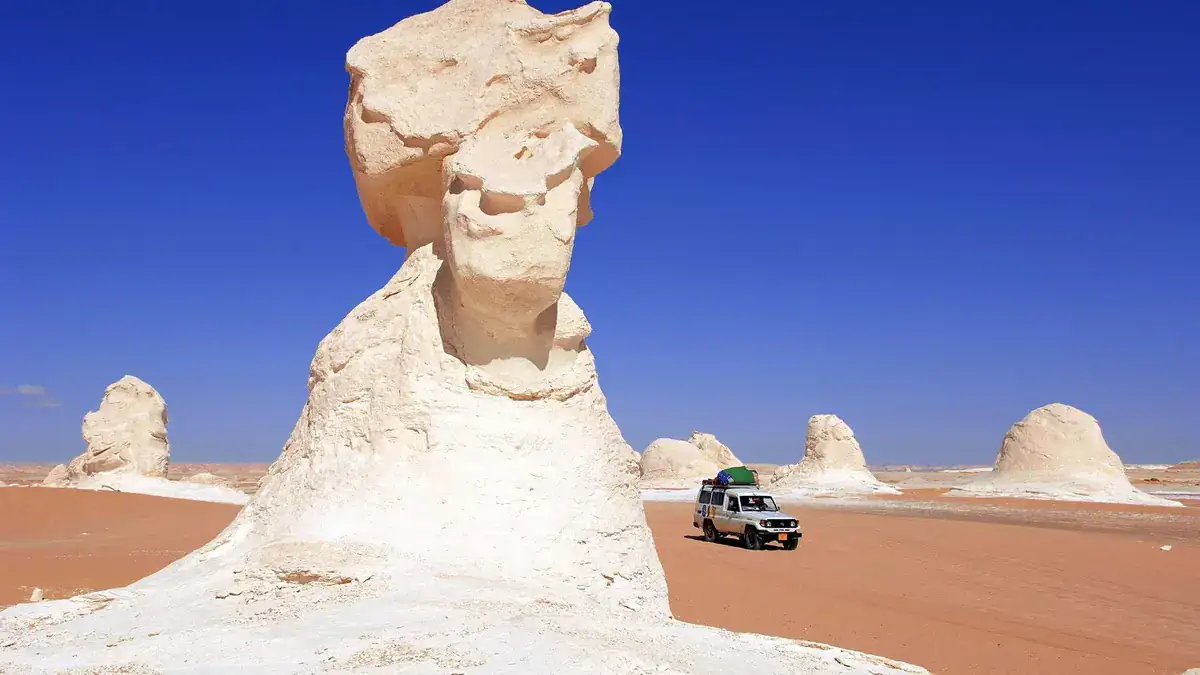 Four wheel drive beside chalk rock formations