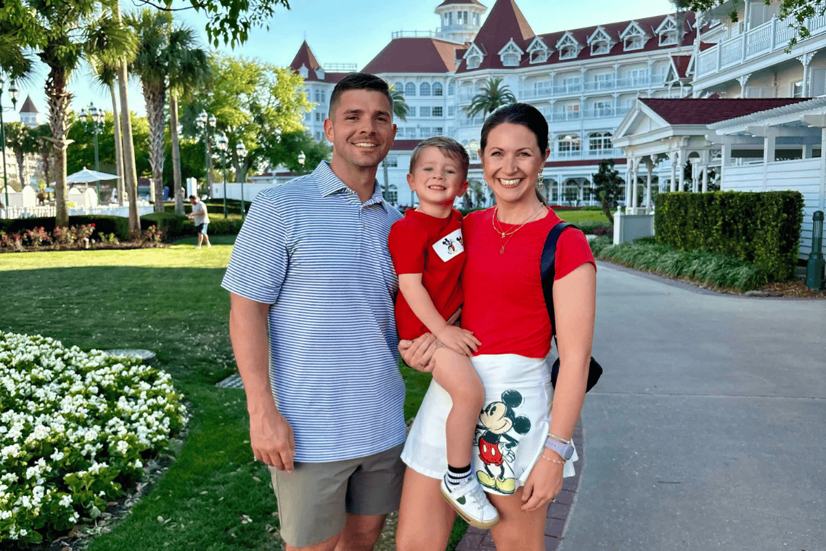 Family at Disney World resort with iconic architecture and lush gardens.
