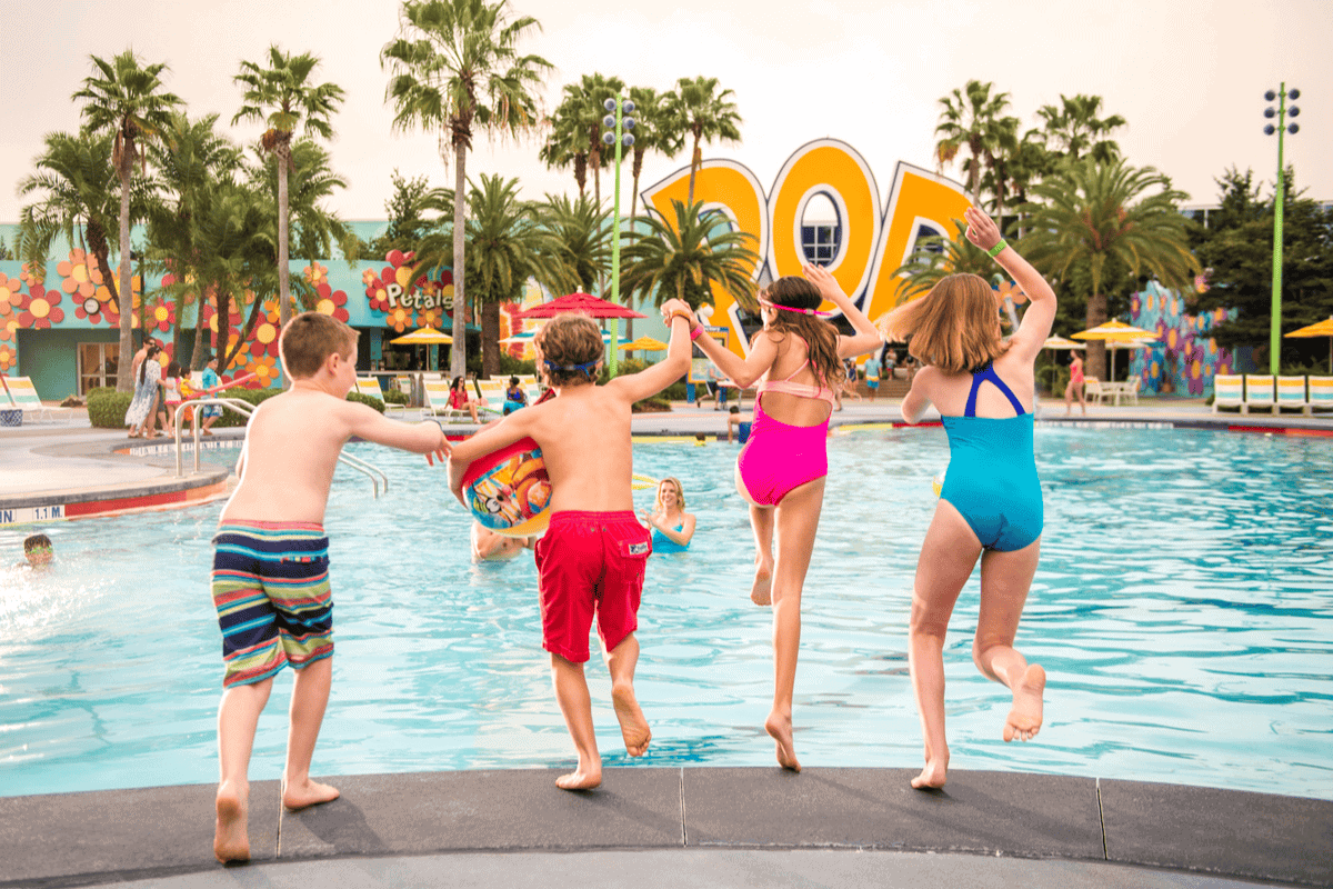 Children enjoying water activities at a vibrant, family-friendly pool area. Perfect for memorable va.