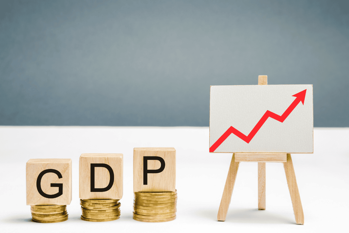 The picture shows Wooden blocks with the word GDP and an up arrow, which symbolizes progress.