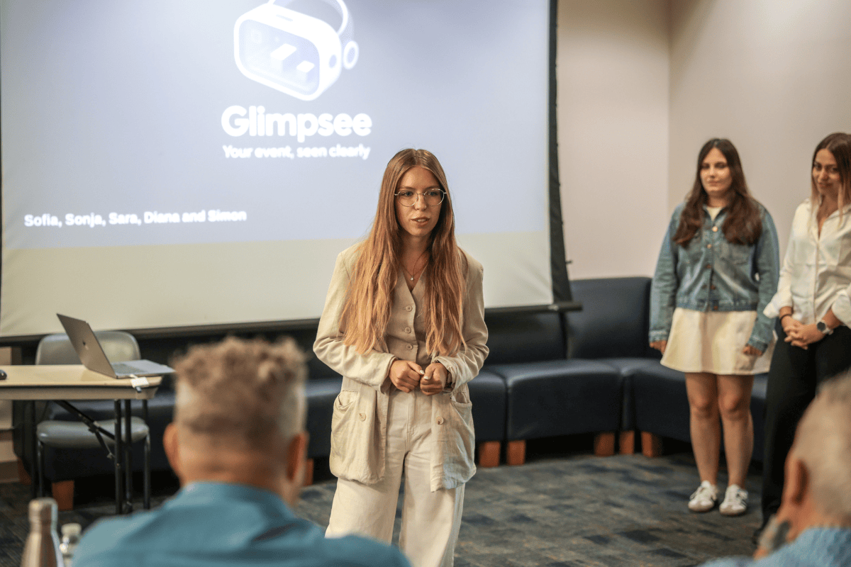 The image shows a woman presenting in front of the judges during ABC Silicon Valley 2025.