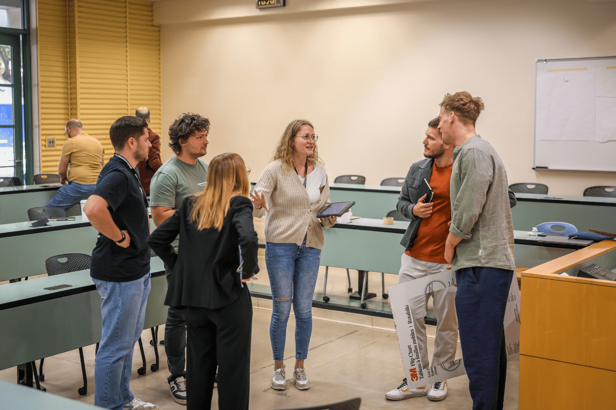 The image shows a team working together to develop their idea.