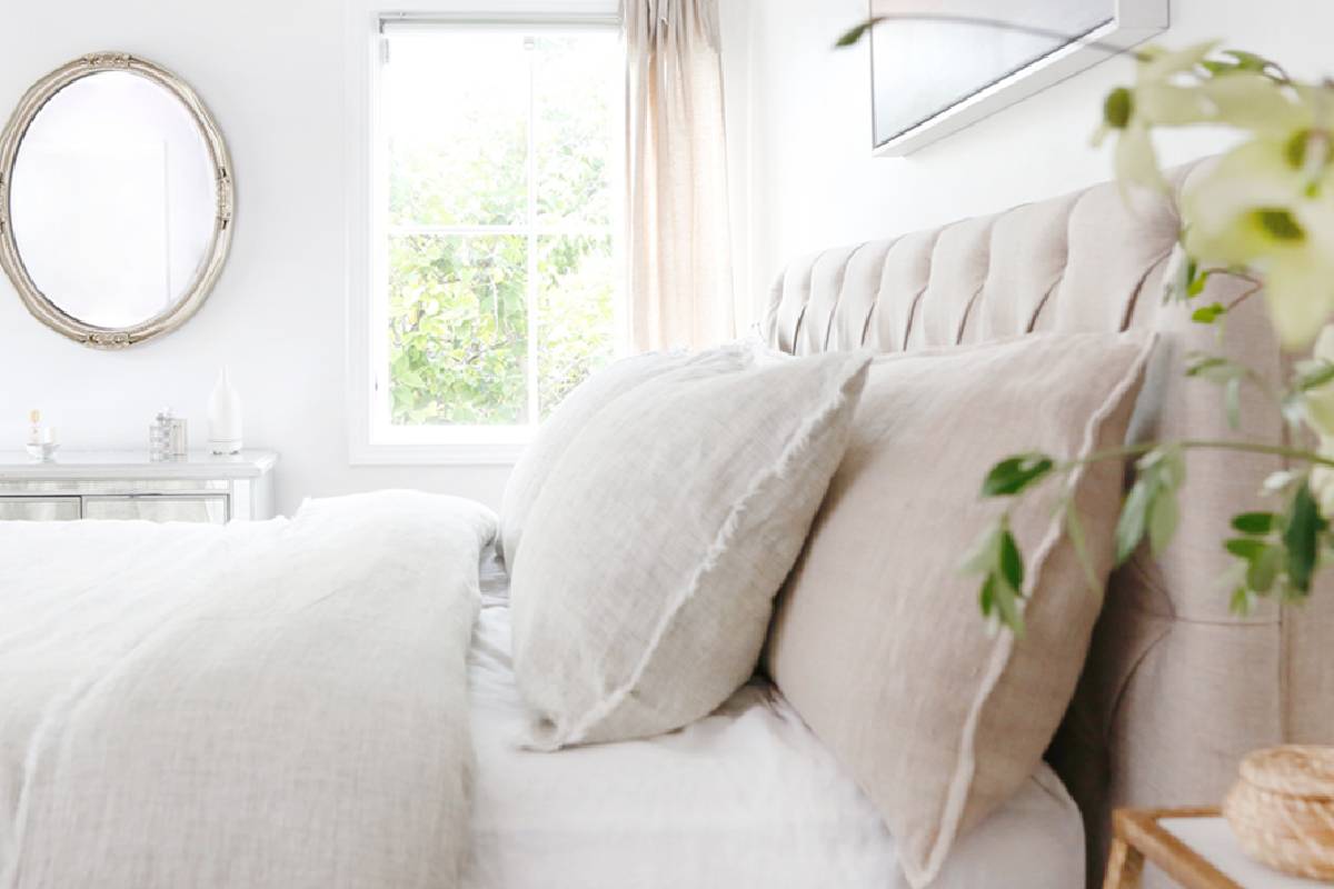 Bright and airy bedroom with plush pillows and natural light.