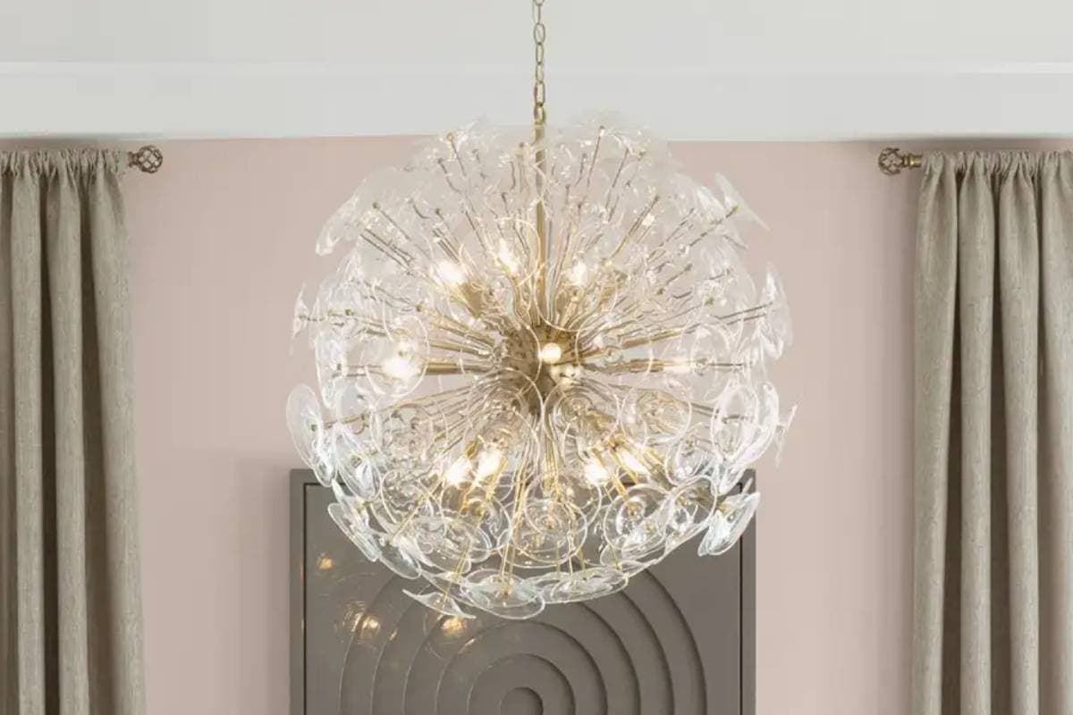 Elegant modern chandelier with glass globes and warm lighting.