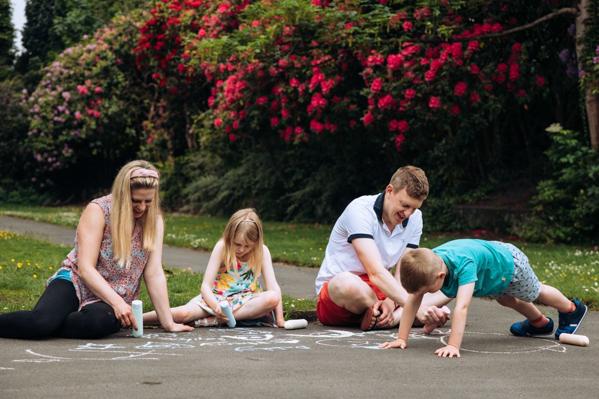 Family writing with chalk