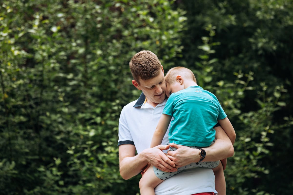 Dad gives son cuddles