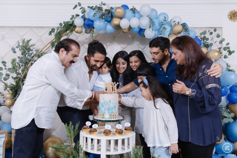 Family gathers around the cake at Viaan's 1st birthday party