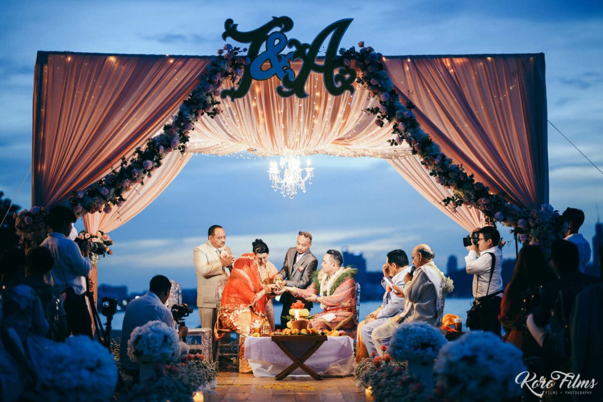 The beach mandap with the couple’s monogram and a chandelier glows at blue hour at Cape Dara Resort, Pattaya