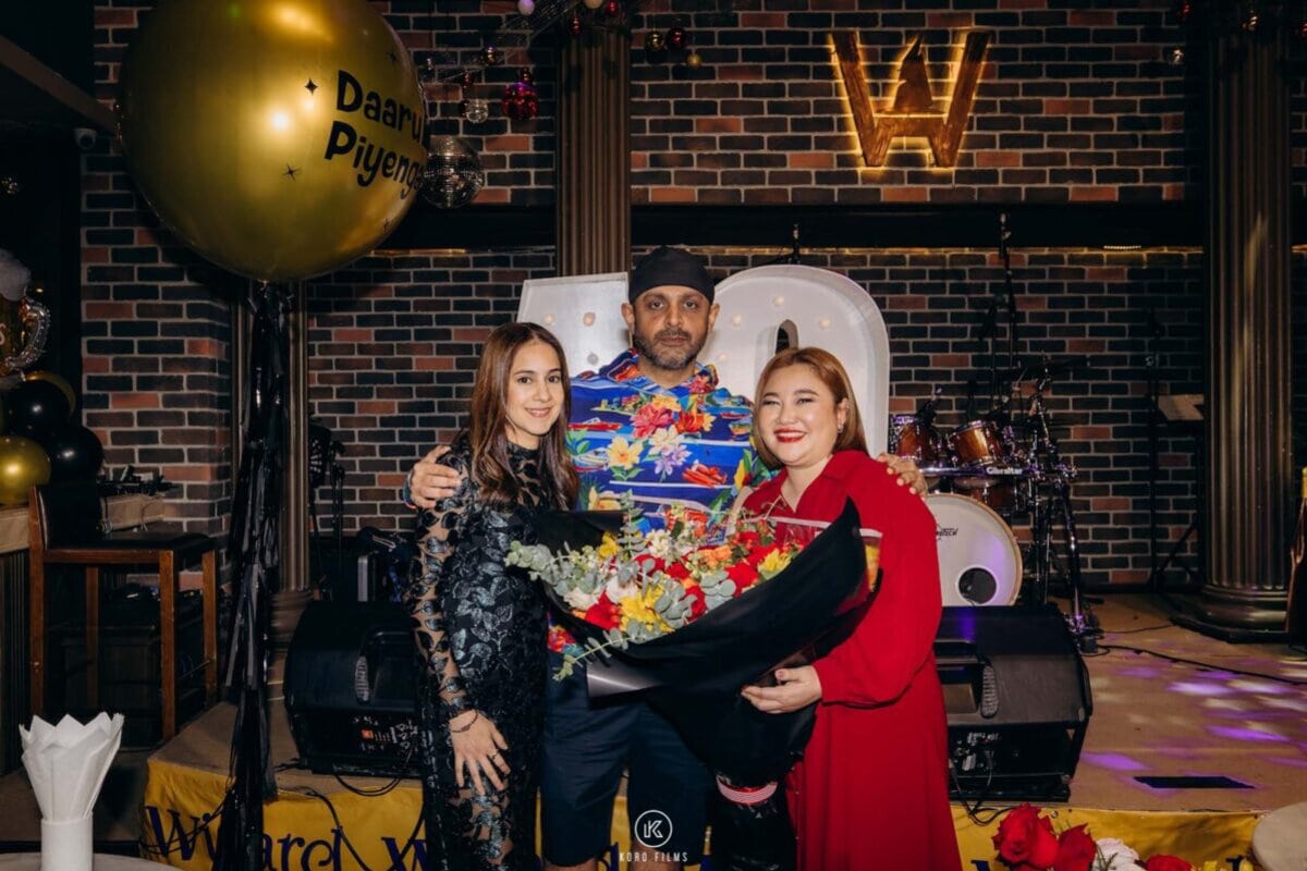 Benny and guests pose with a gold balloon at his 40th birthday party at Wizard Brewery, Pattaya