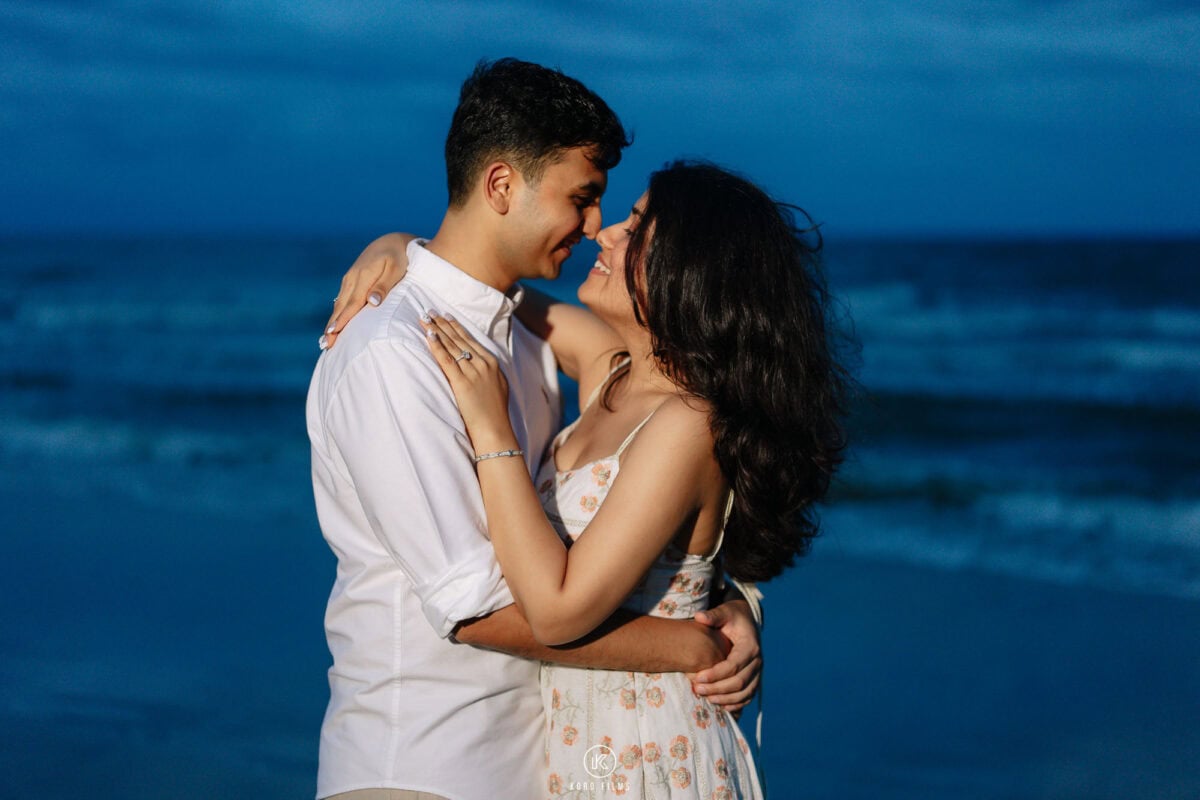Vatsal and Paridhi share a laugh in a close embrace on Hua Hin beach at blue hour
