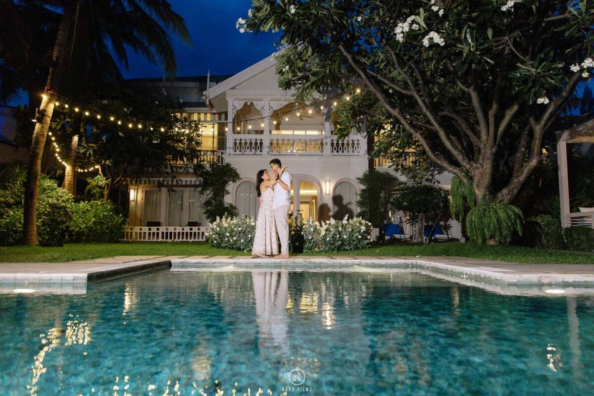 La Residence Villa lit up at night and reflected in the pool, with Vatsal and Paridhi on the lawn, InterContinental Hua Hin