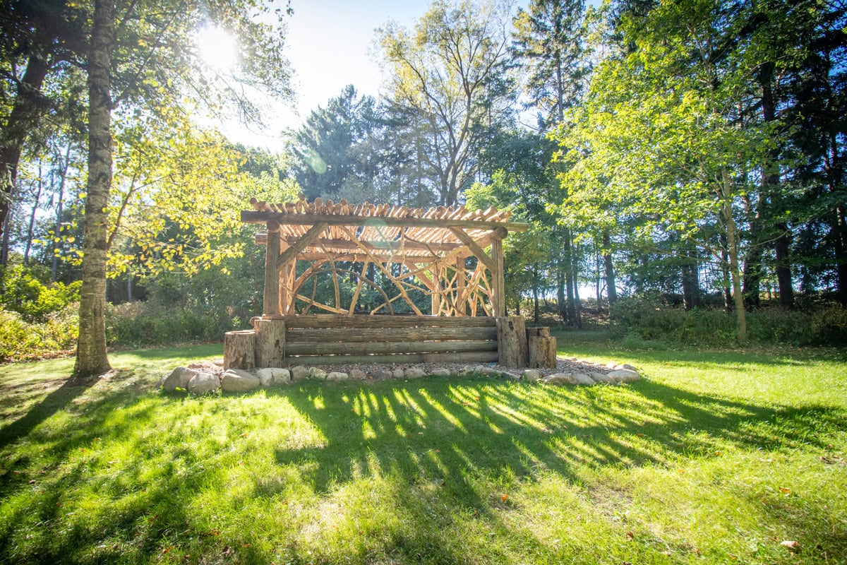 log Pergola with furniture on lawn