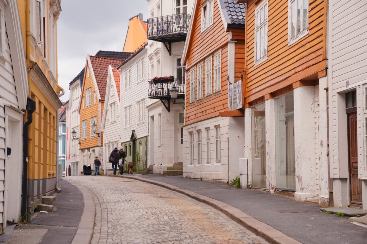 View of central street with wooden houses in Bergen on a cloudy day