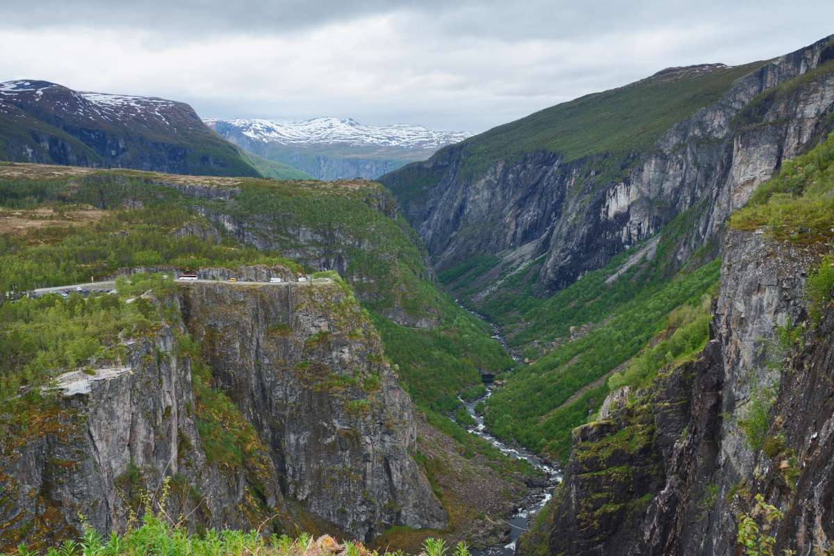 Lush canyon in norway, with winding water stream in the middle