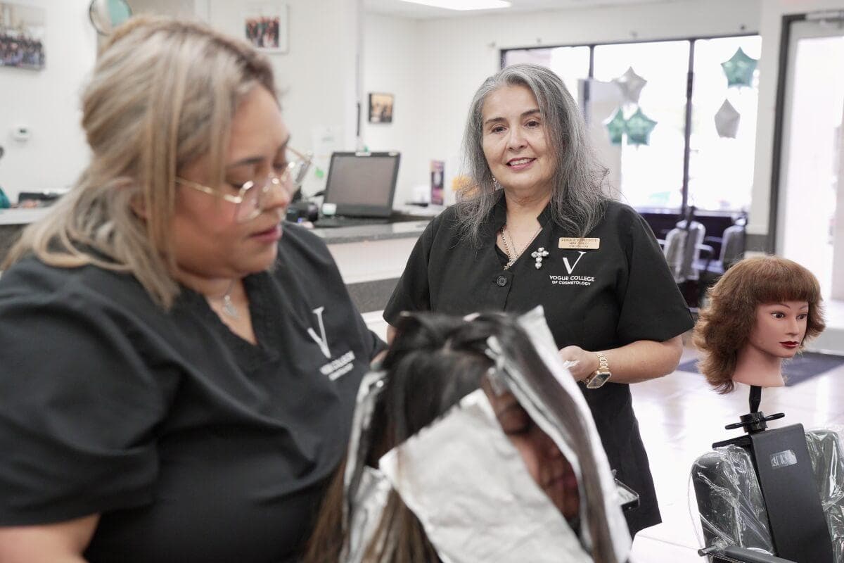 Cosmetologist smiling at camera standing in salon