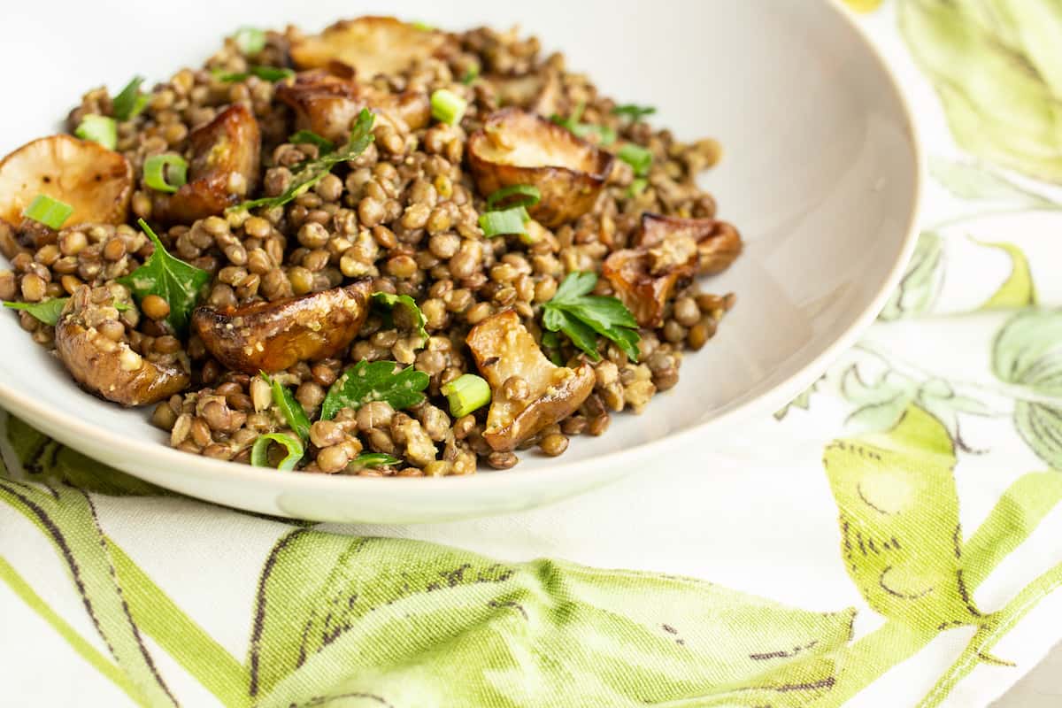 A warm lentil salad mixes French lentils with roasted Jerusalem artichokes, or sunchokes, in a cozy and comforting vegetarian winter dish.