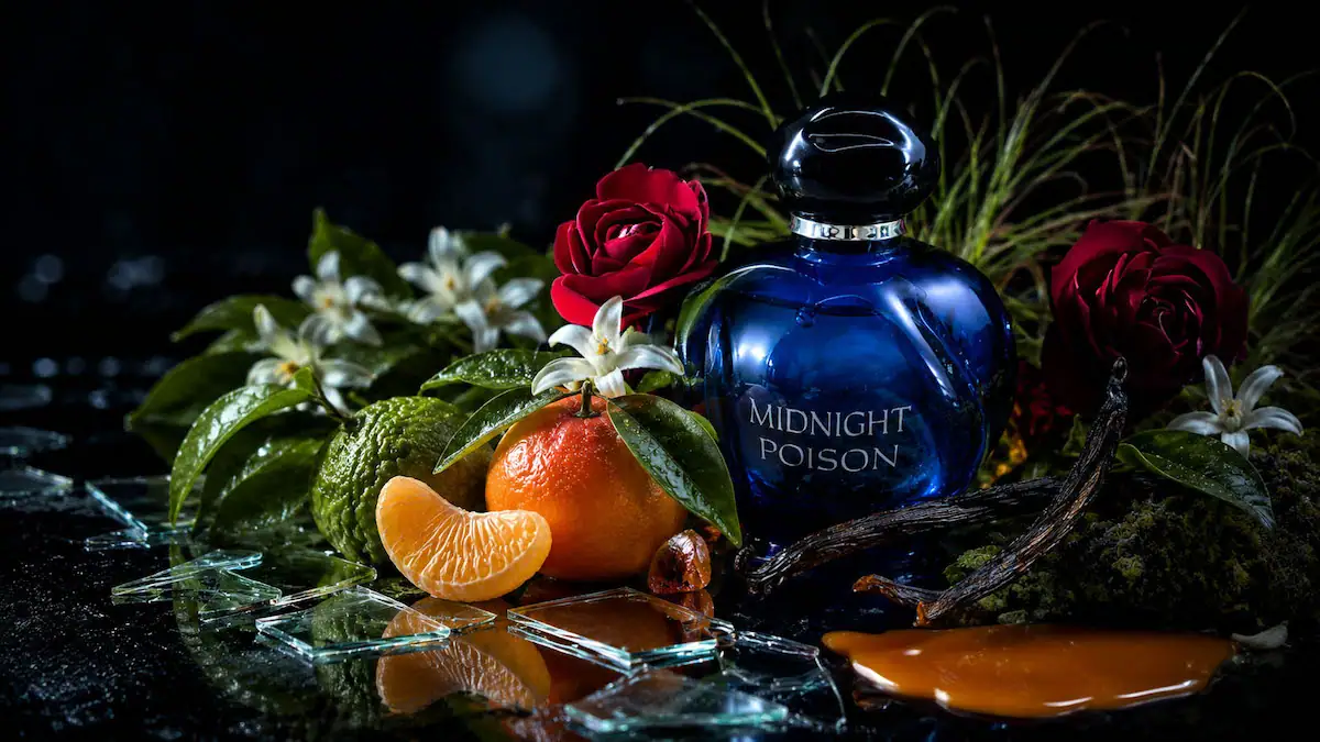 Dior Midnight Poison perfume bottle in deep sapphire blue glass with dark rose and chypre fragrance atmosphere