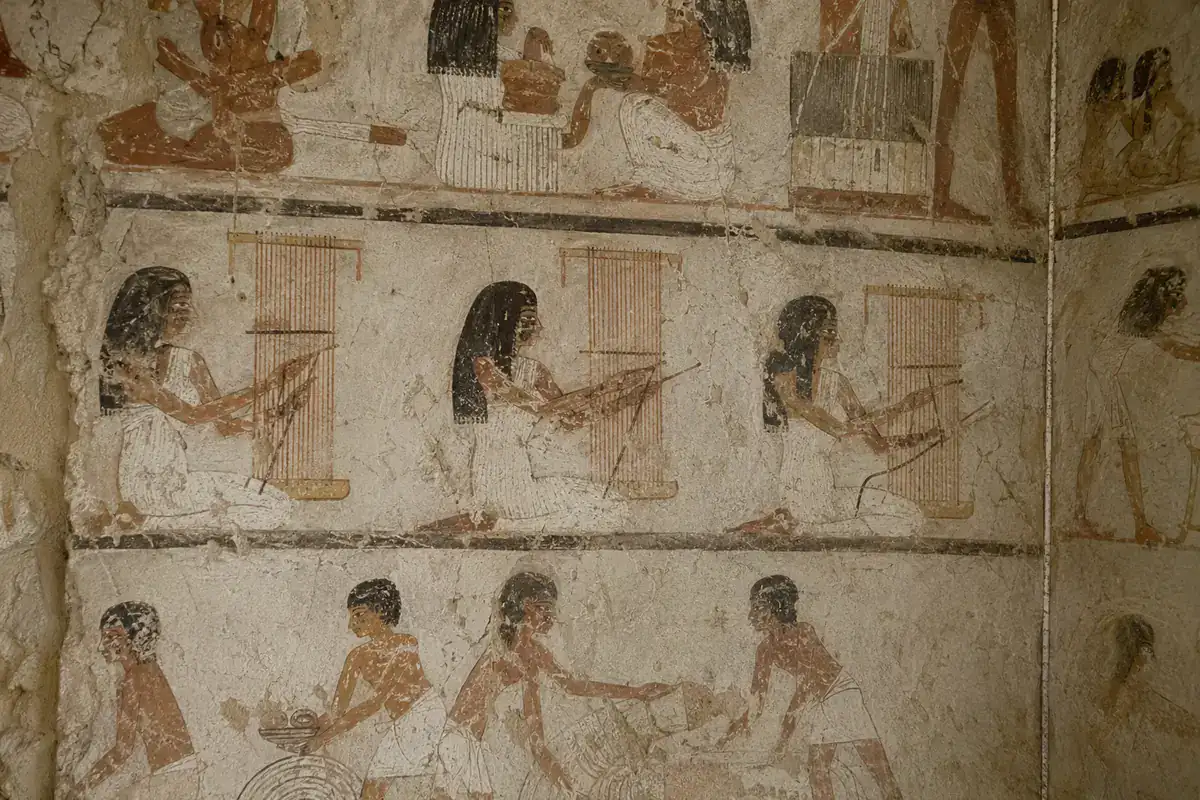 Ancient weaving and craft scenes on painted plaster