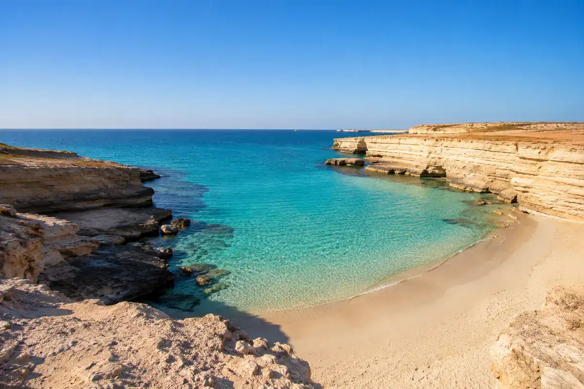 Turquoise water and limestone cliffs at Agiba Beach Marsa Matrouh Egypt