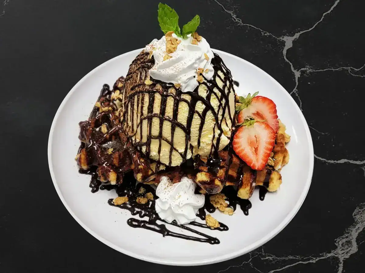 Le Choco Belgian Waffle with whipped cream, chocolate drizzle and strawberries at Arcane Maid Café