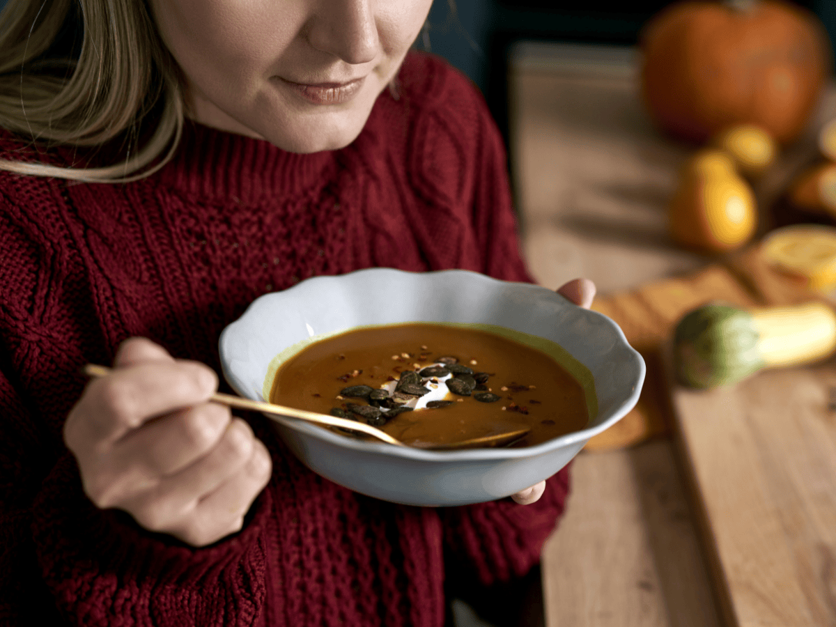 woman eating pumpkin soup