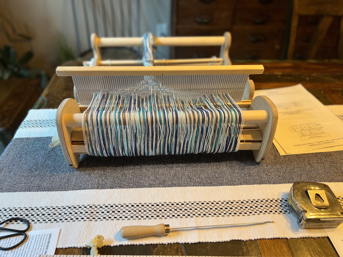 Warped loom on table with hook