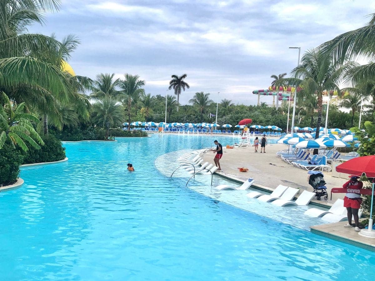 large pool with chairs and umbrellas surrounding it