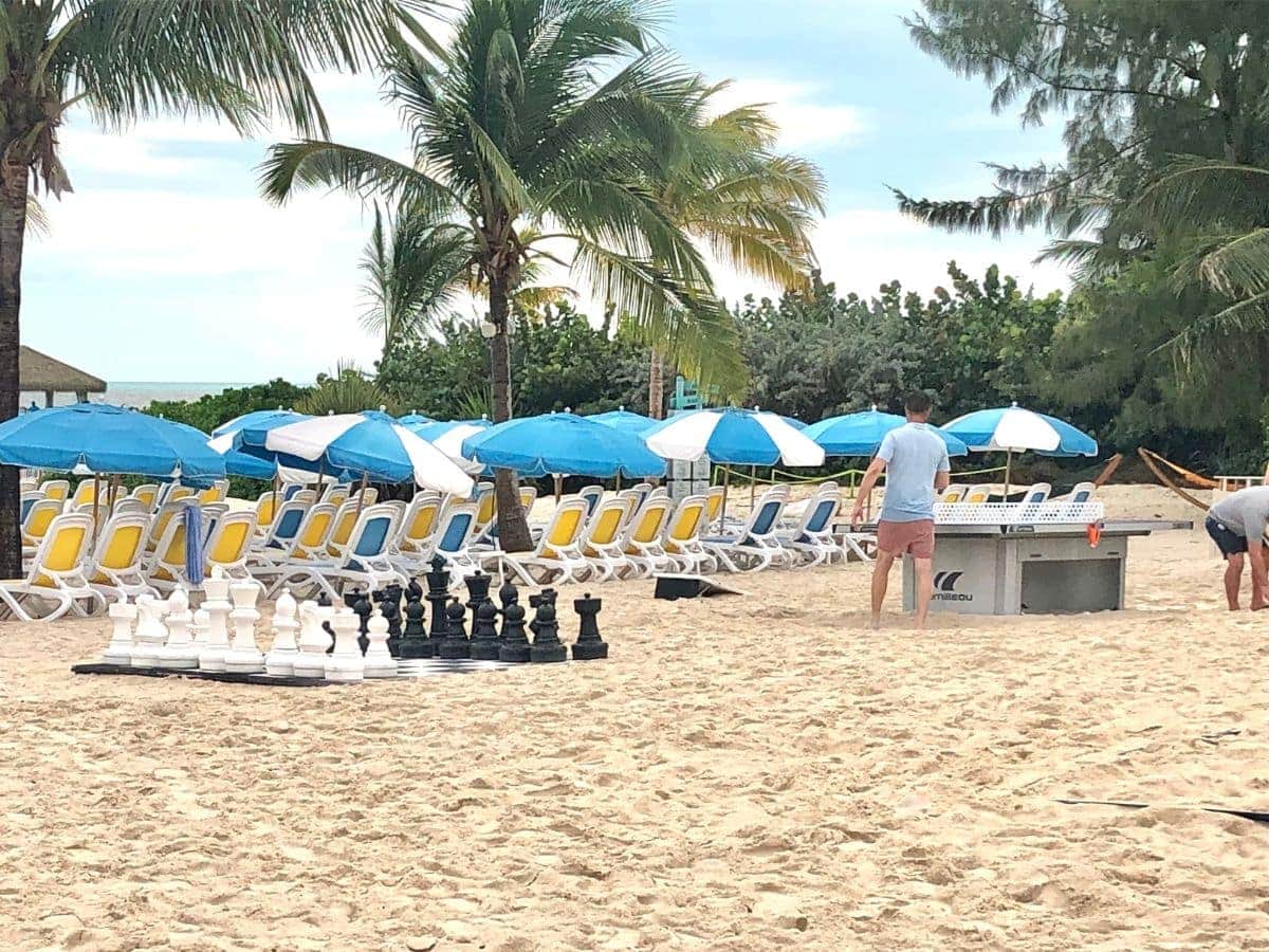 Beach chess and air hockey on sand with lounge chairs