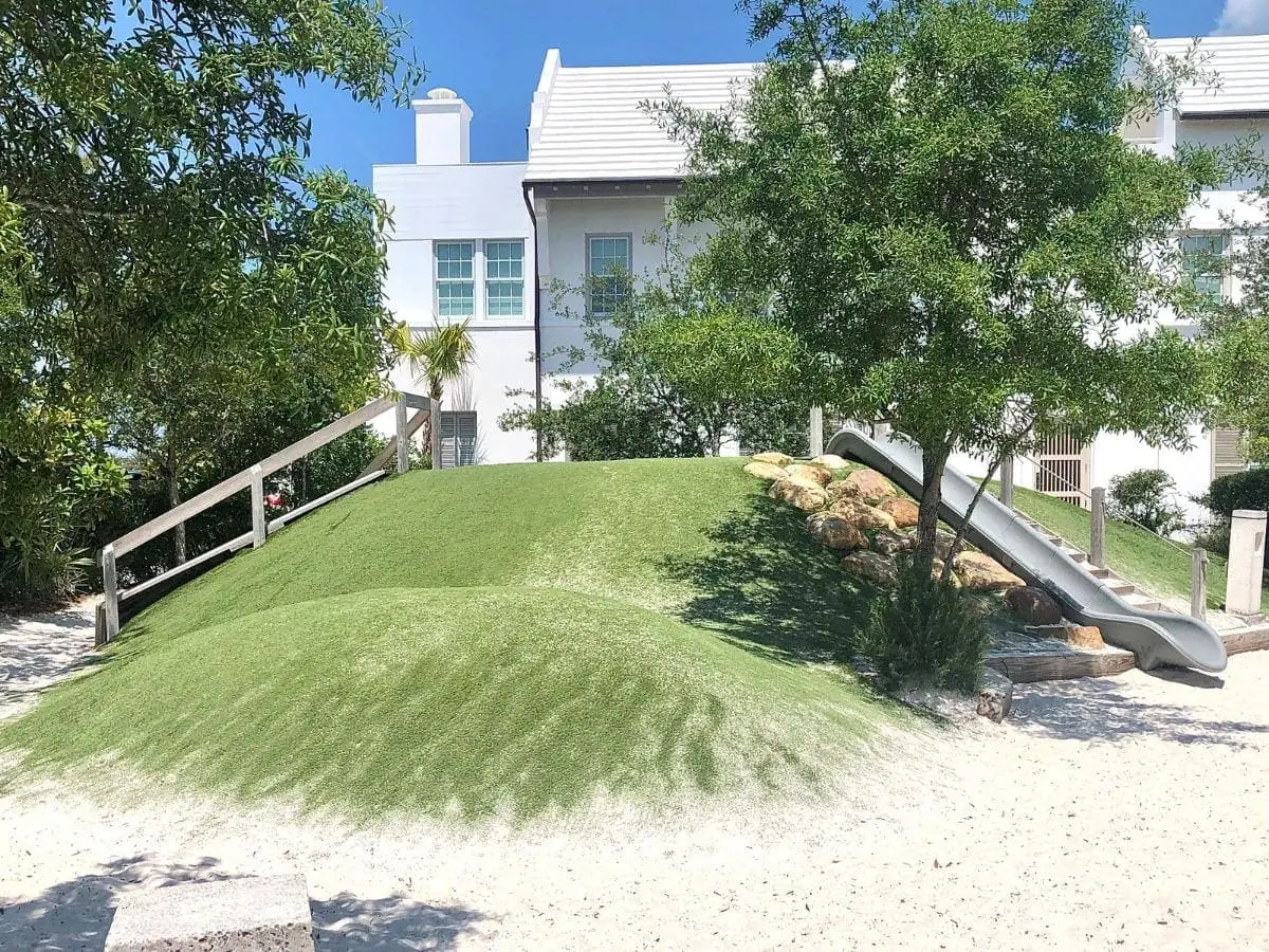 grassy hill with steps and slide built in