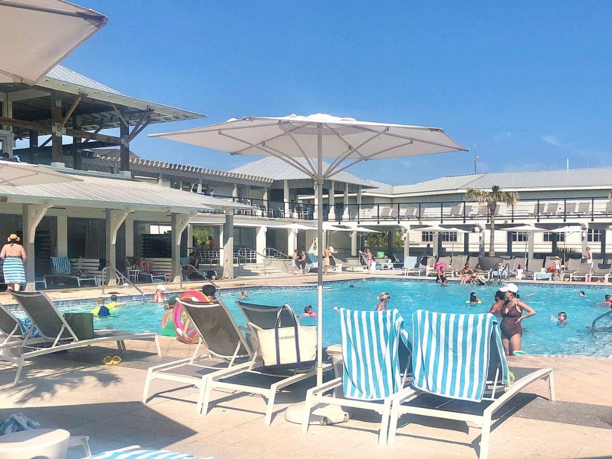 swimming pool with lounge chairs and cabanas