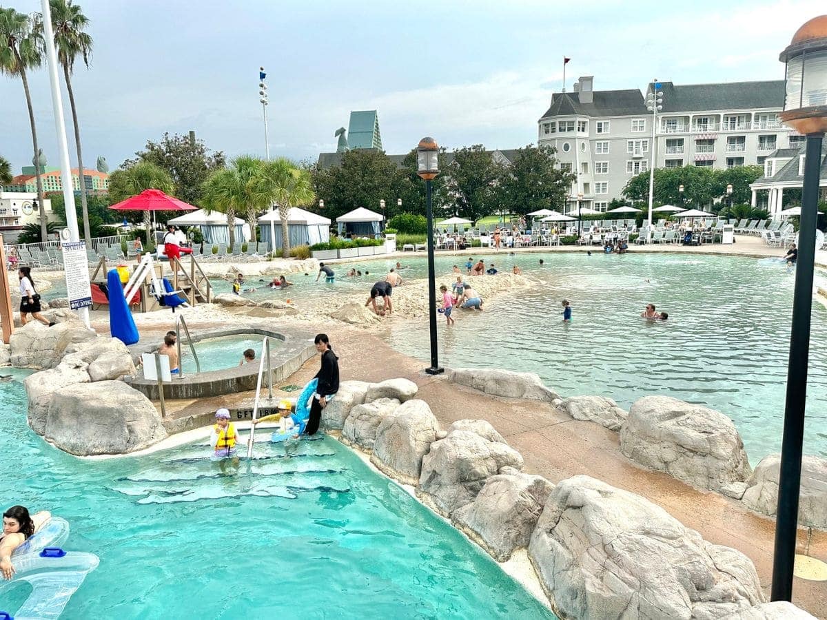 sand bottom pool with Disney's Yacht Club in background