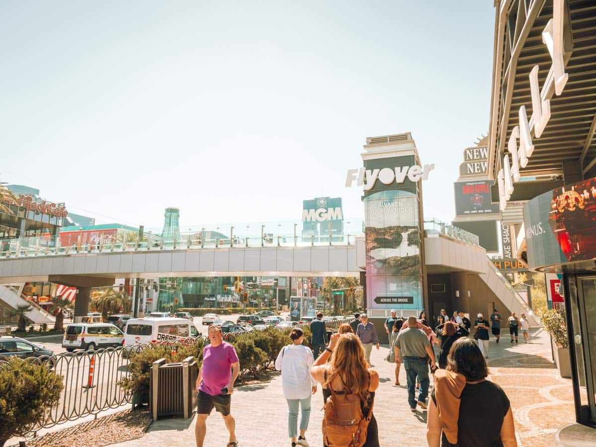 Las Vegas Strip on a hot March day looking at the Flyover sign and bridge crossing the strip.