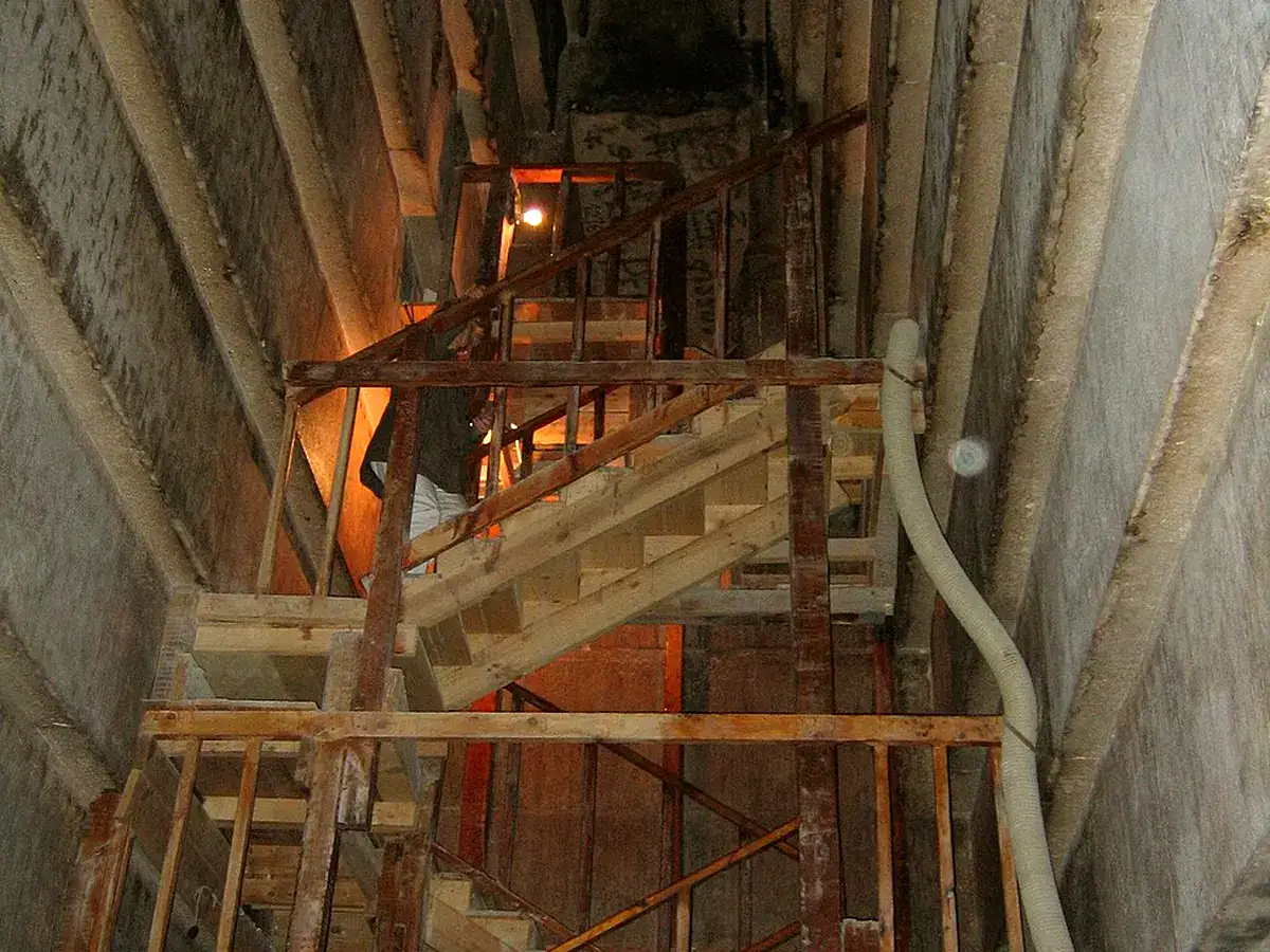 Steep descending passage with wooden steps and handrails