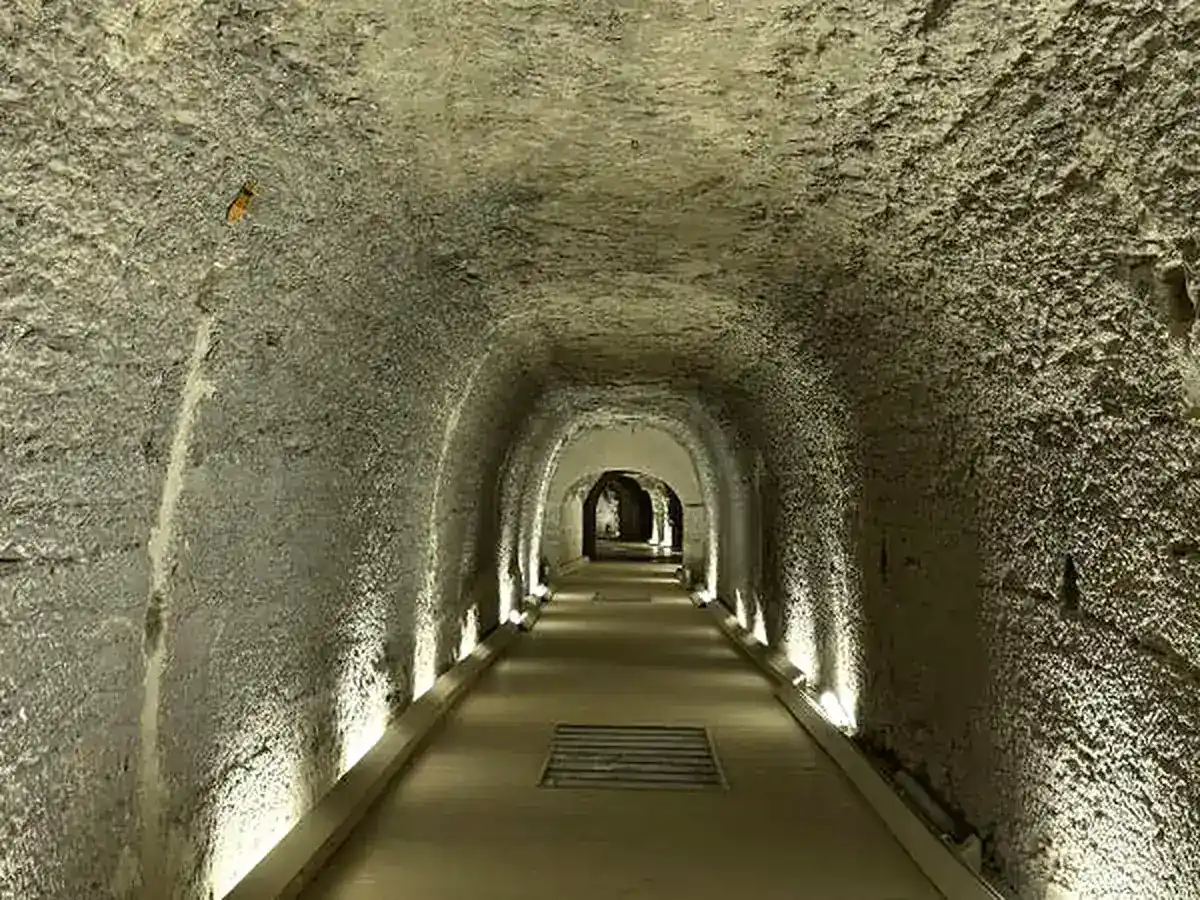 Long illuminated rock-cut gallery beneath Saqqara