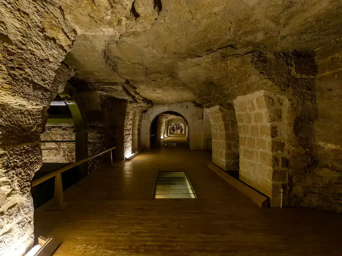 Subterranean chamber with stone supports and a wooden walkway