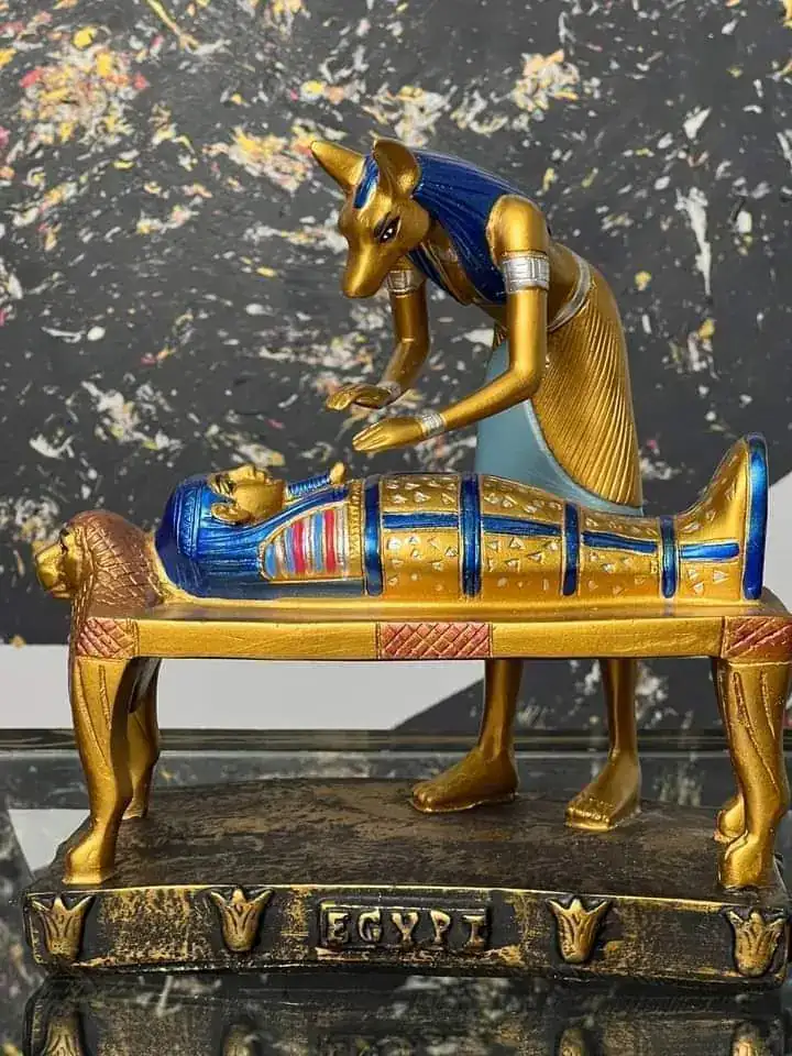 Modern decorative replica of Anubis attending a mummy