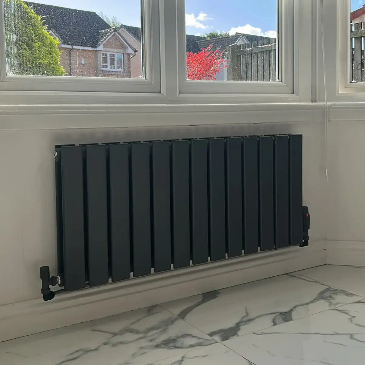Completed horizontal anthracite designer radiator installation completed in Moodiesburn, Glasgow G69 North Lanarkshire.