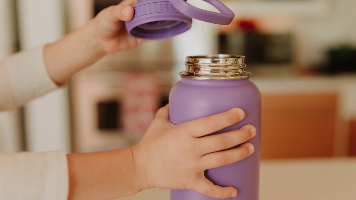 hands opening a water bottle cover