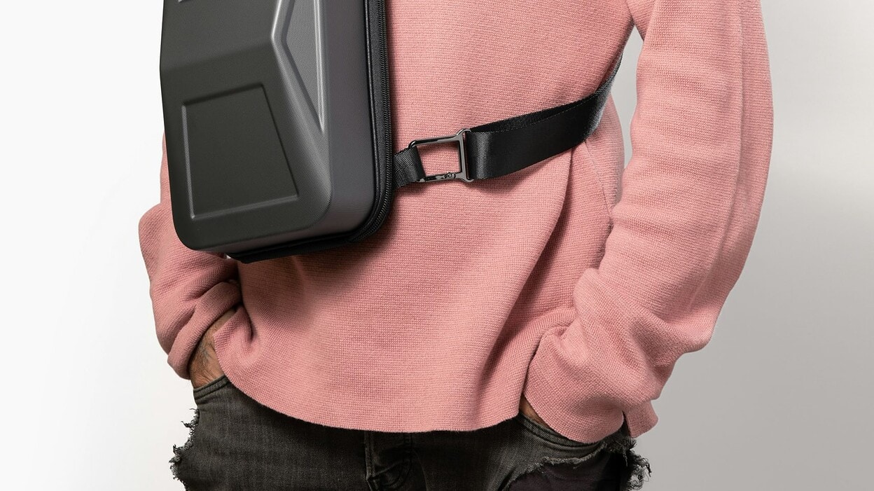 person wearing backpack purse