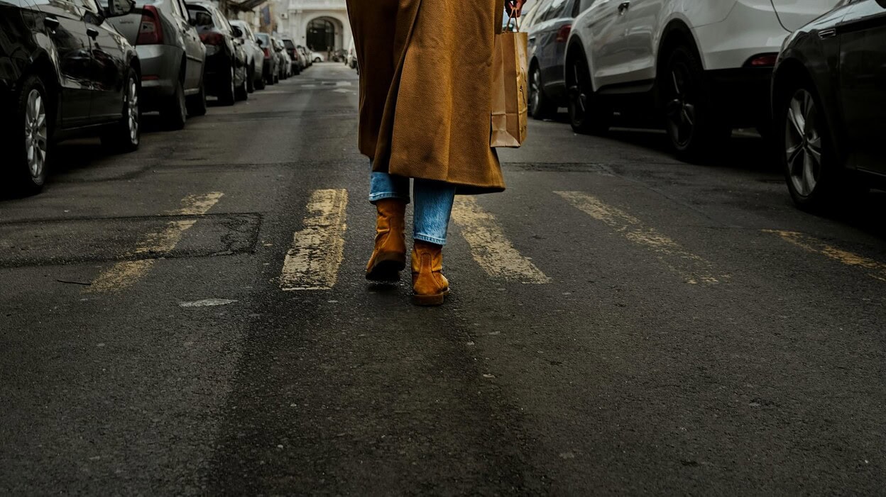 woman wearing a sling backpack
