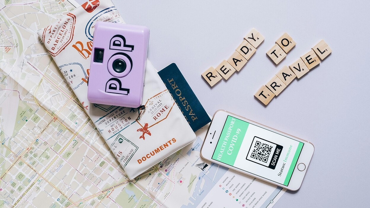 Smartphone and passport placed on map