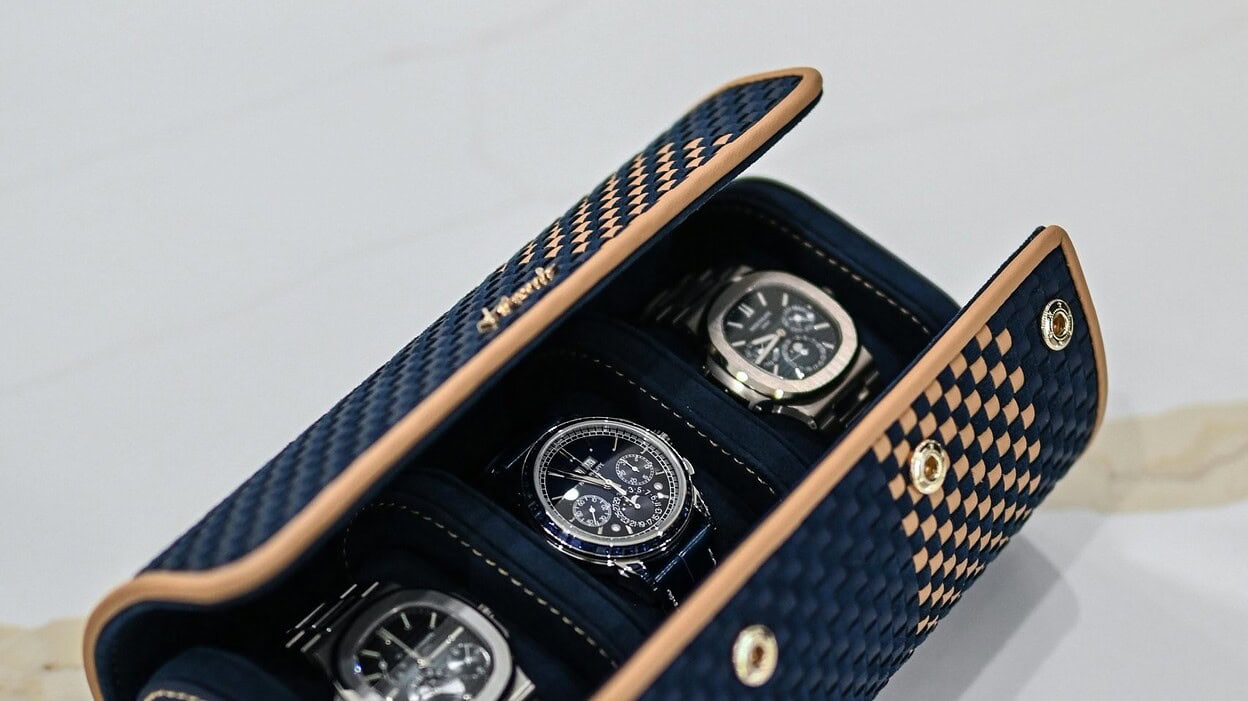 A watch case with 3 watches