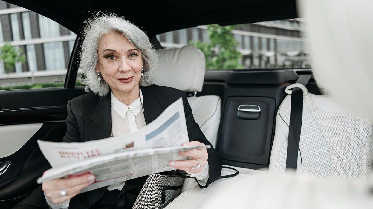 Elderly Woman holding a newspaper