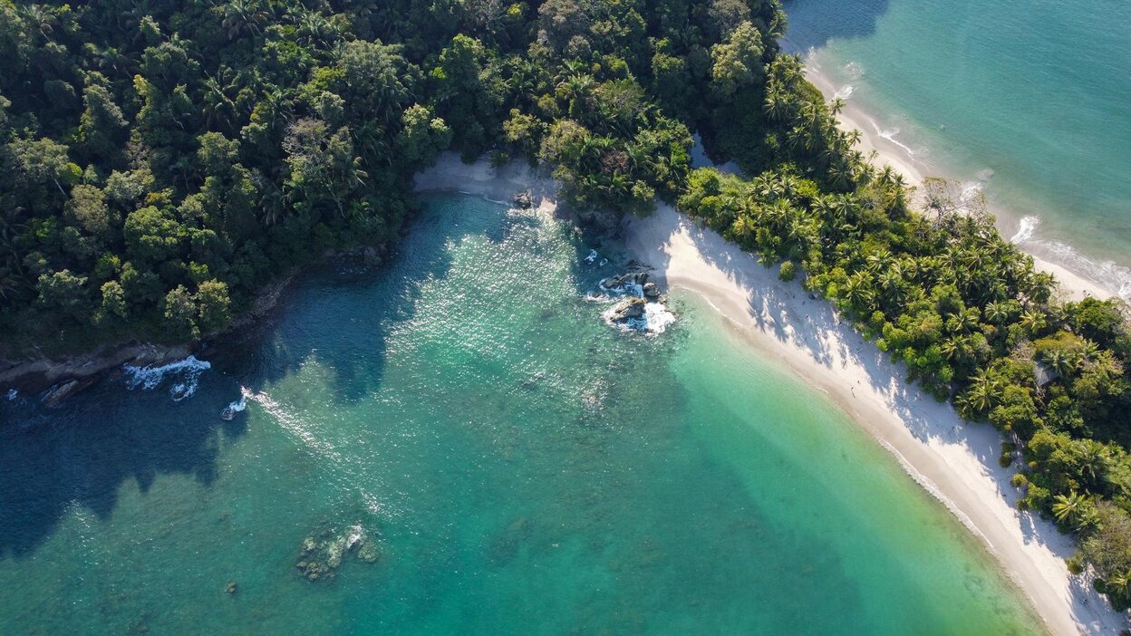 an aerial shot of the manuel antonio beach in costa rica