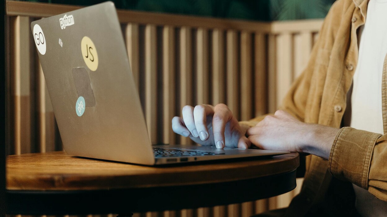 person using a silver laptop