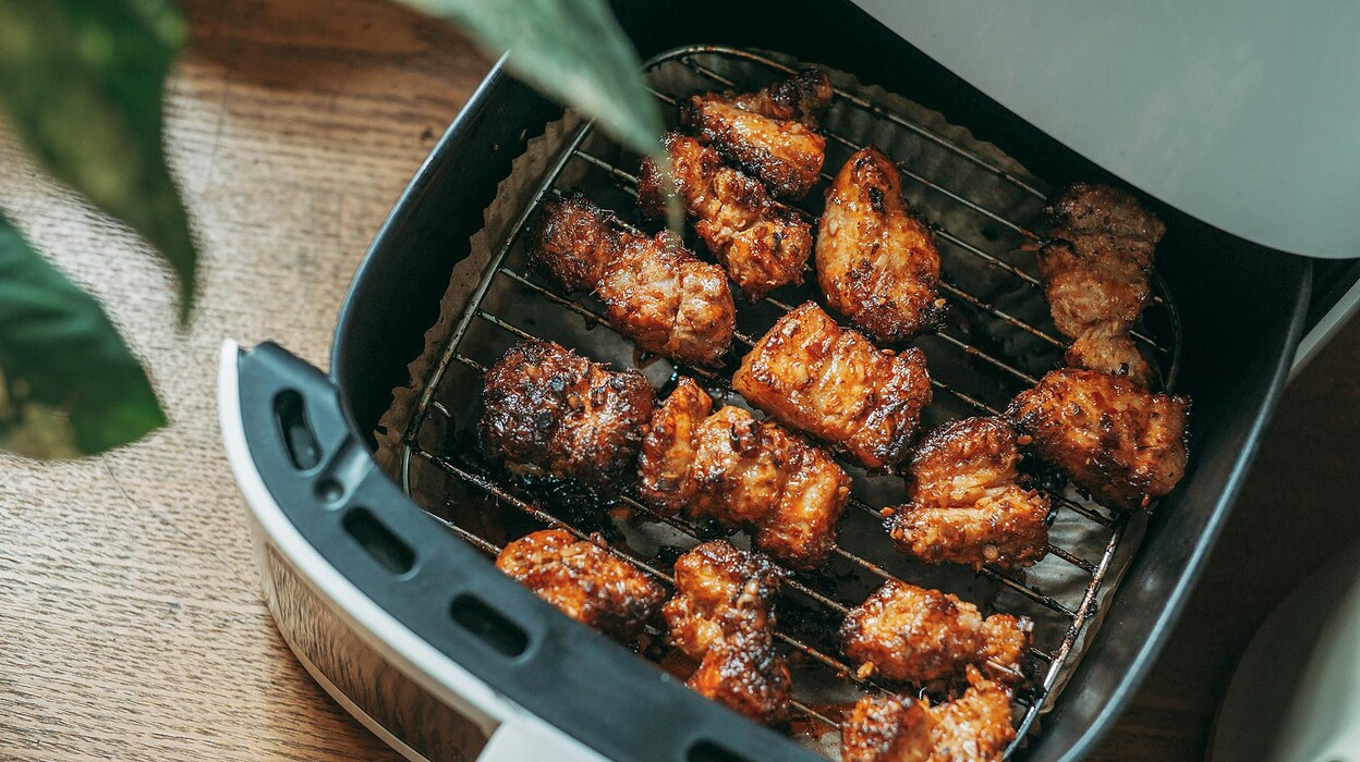 crispy chicken pieces in modern air fryer