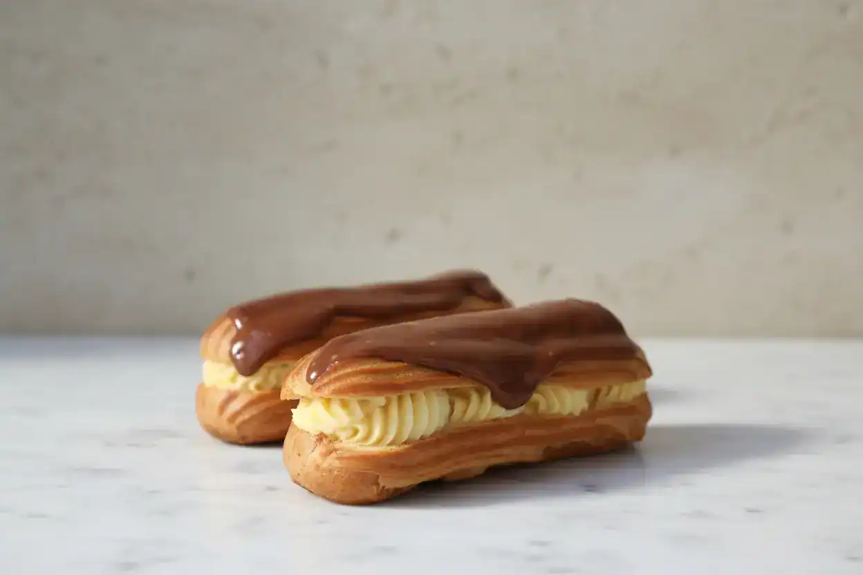 Handcrafted chocolate éclairs with vanilla pastry cream filling at Prestige Patisserie Choux Pastry & Éclair Masterclass in London
