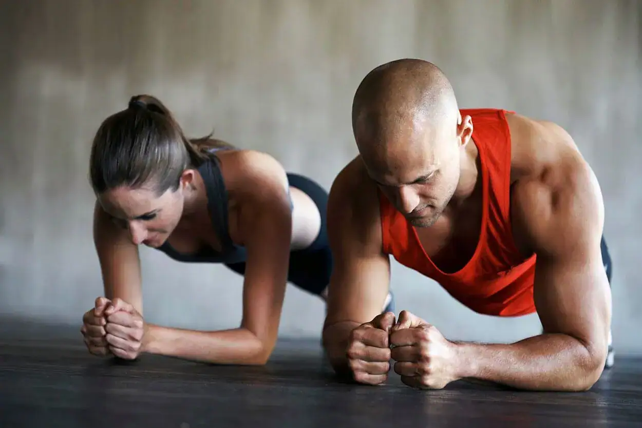 man and woman in a high plank position