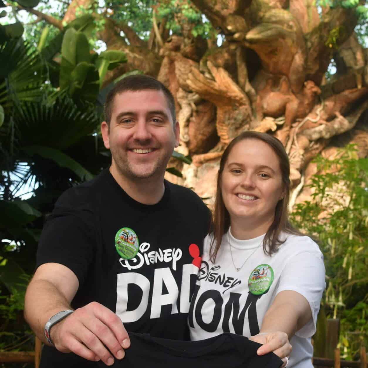 Vibrant couple enjoying Disney World vacation at Animal Kingdom themed area.